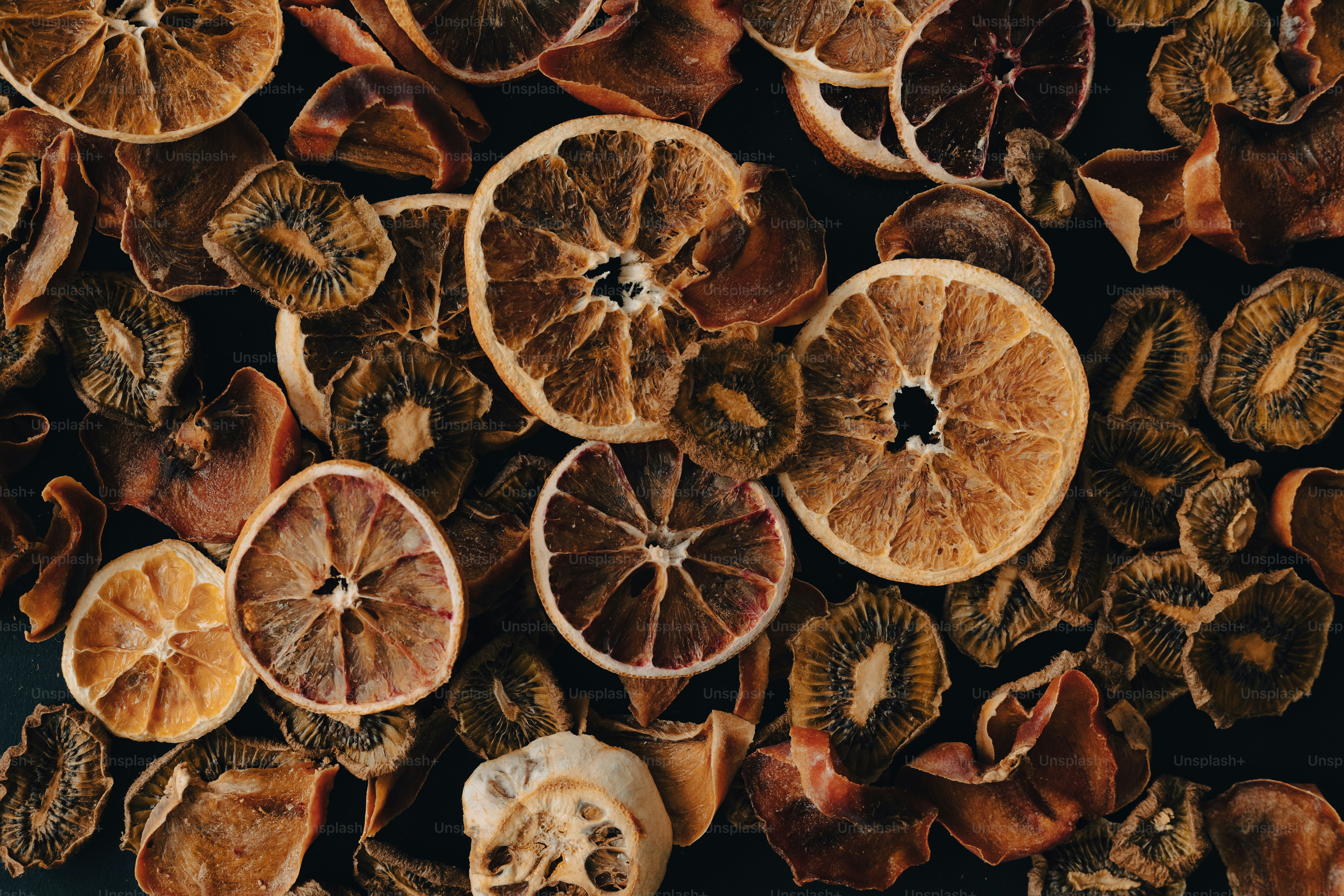 a bunch of oranges cut in half on a table