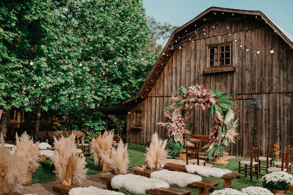 a rustic barn with a wreath on the front of it