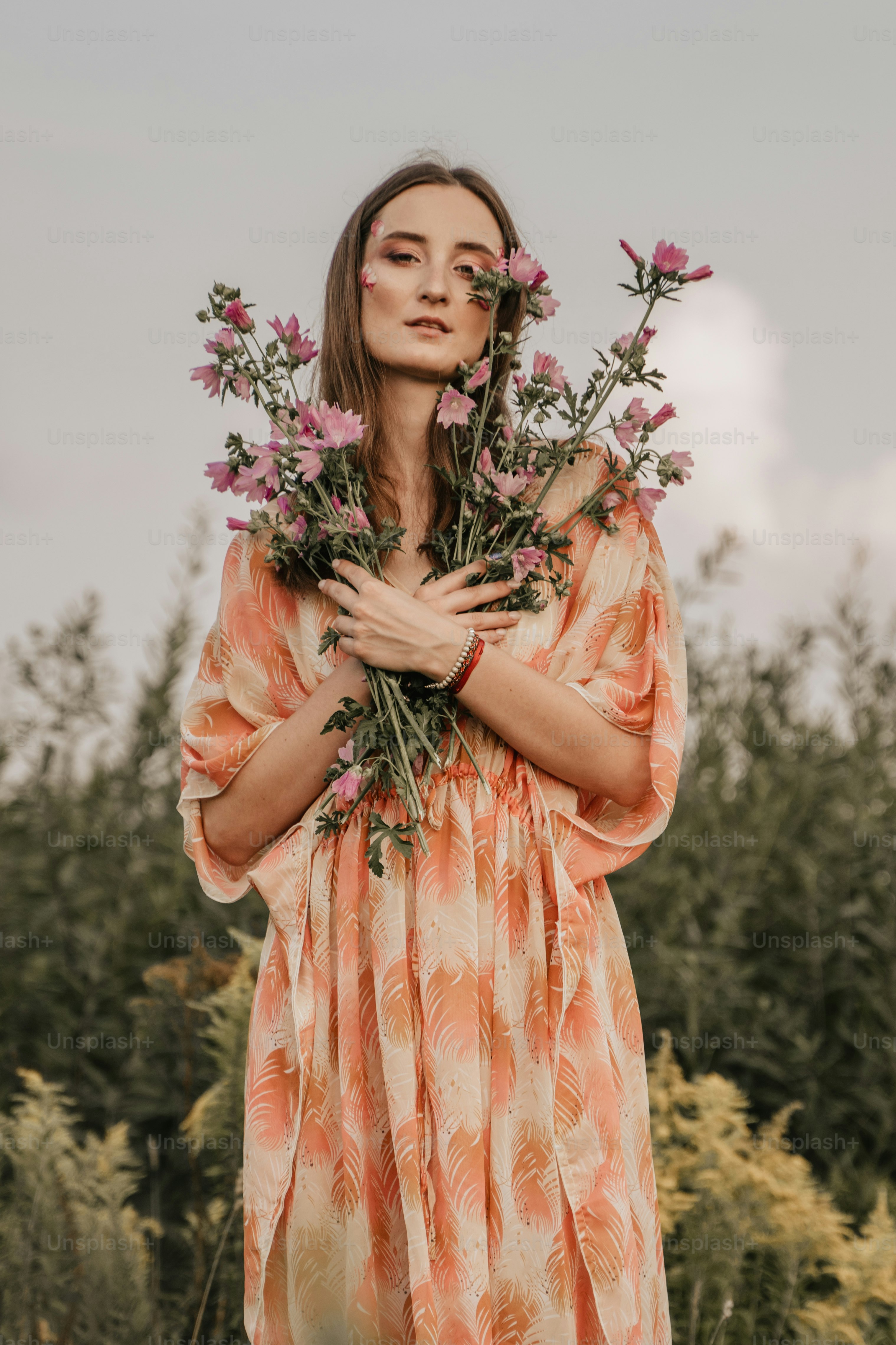 A woman holding a bunch of flowers in her hands photo – Meadow Image on ...