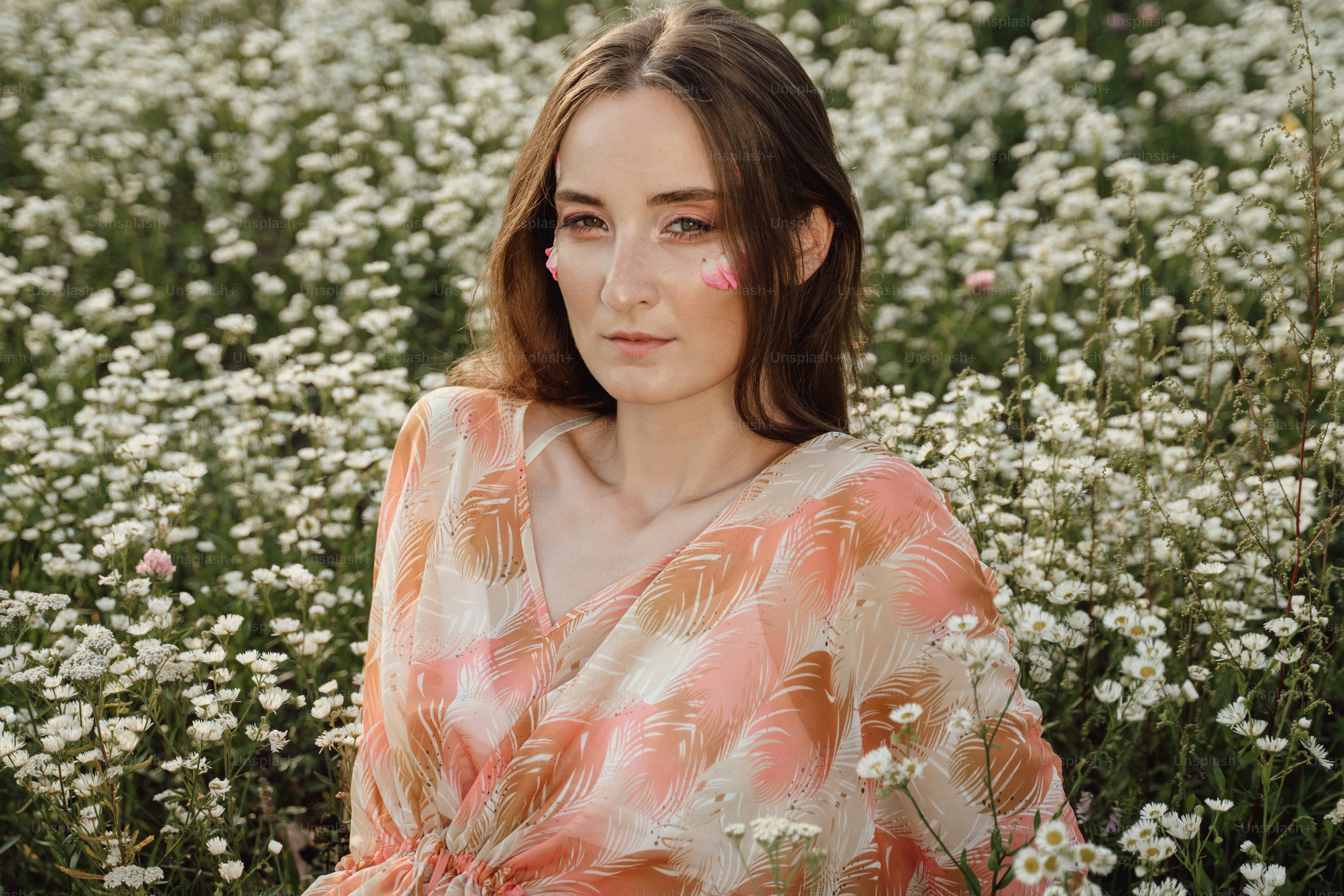 a woman standing in a field of white flowers
