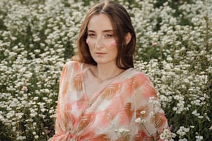 a woman standing in a field of white flowers