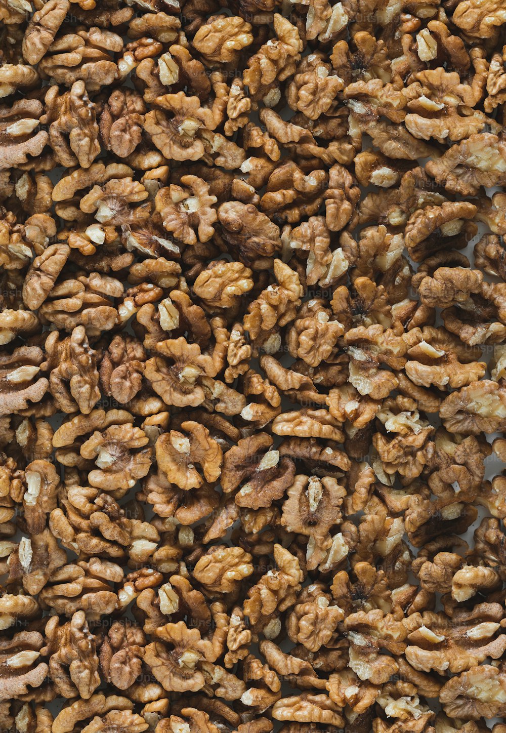 a large pile of walnuts sitting on top of a table