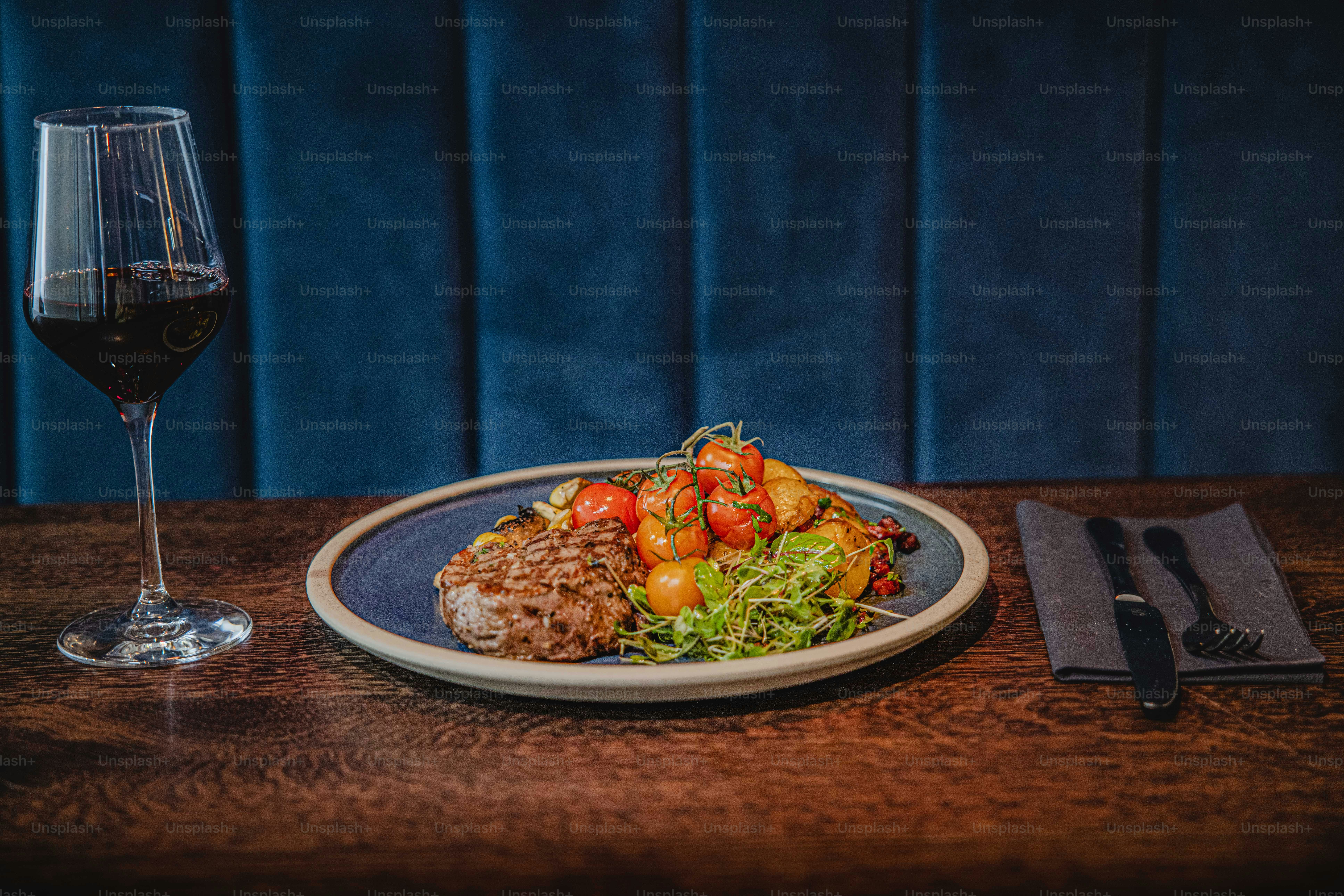 A plate of food on a table with a glass of wine photo – Food and drink ...