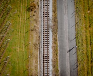 uma vista aérea de uma trilha de trem no meio de um campo