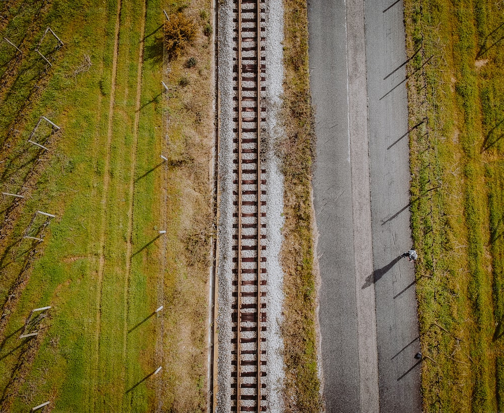 an aerial view of a train track in the middle of a field