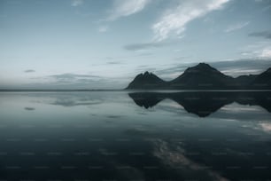 a large body of water with mountains in the background