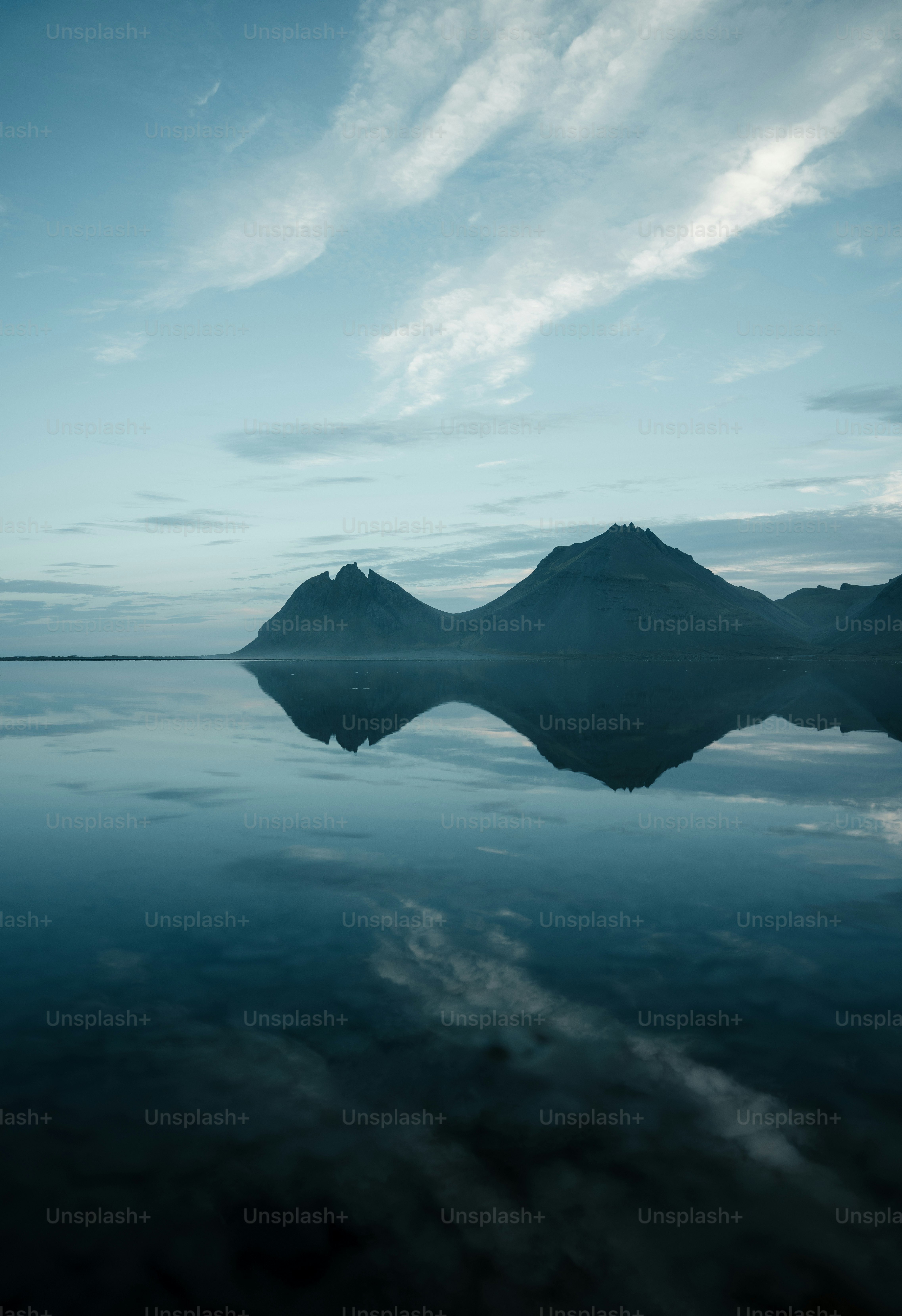 a large body of water with mountains in the background