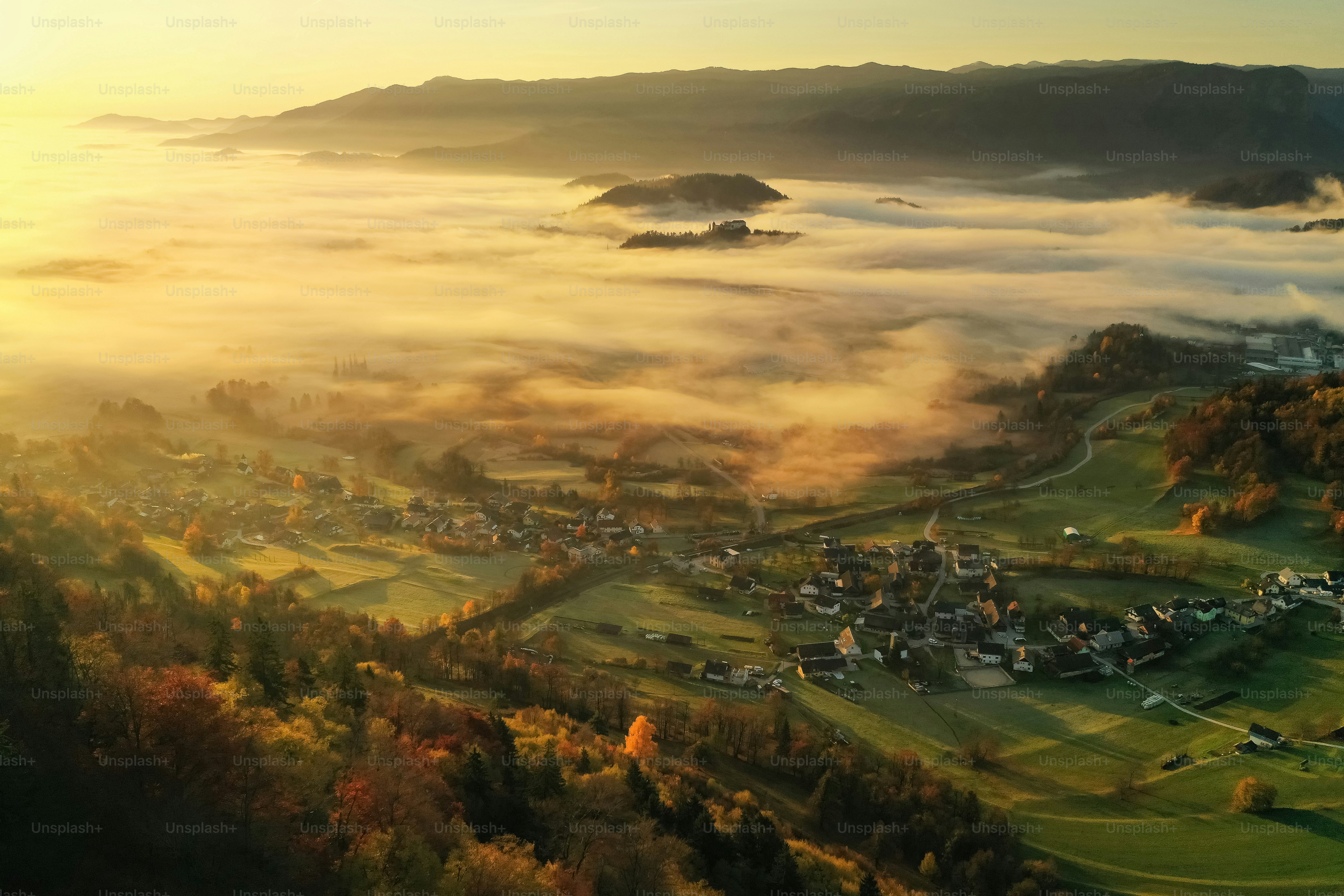 an aerial view of a town surrounded by fog