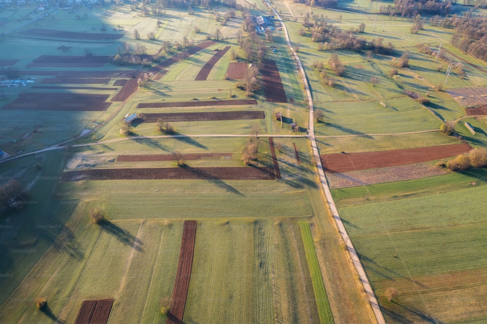 an aerial view of a field with a train on the tracks