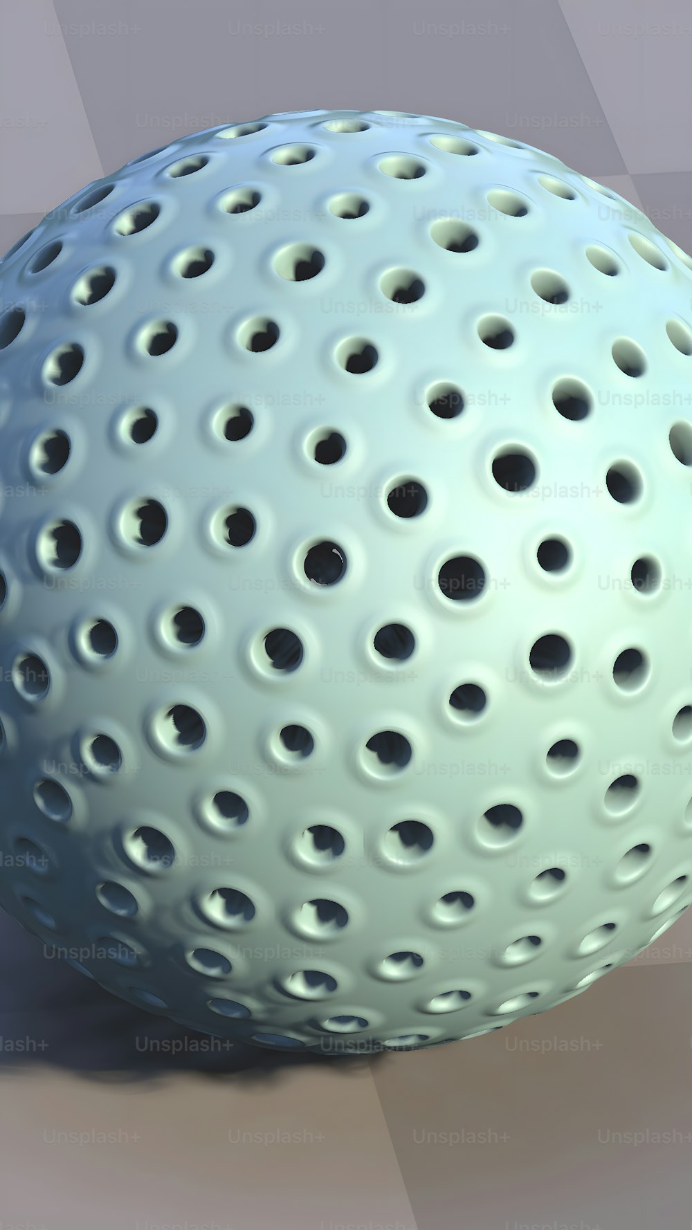 a close up of a white ball with holes on it