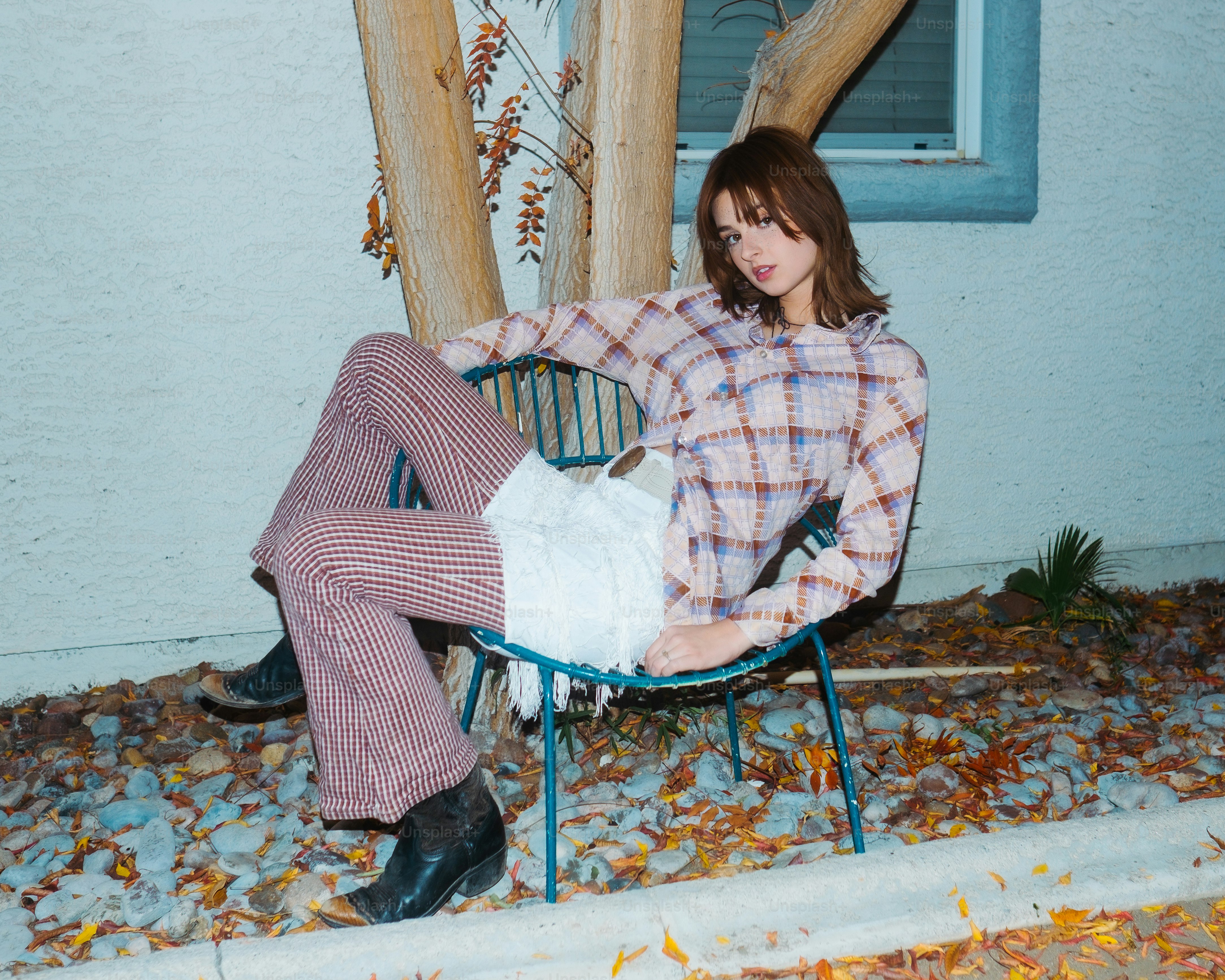 a woman sitting on a chair with her legs crossed