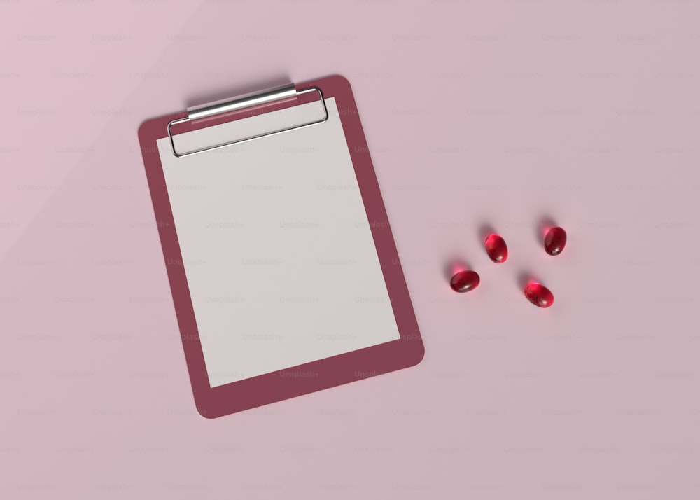 a clipboard and three pills on a pink surface