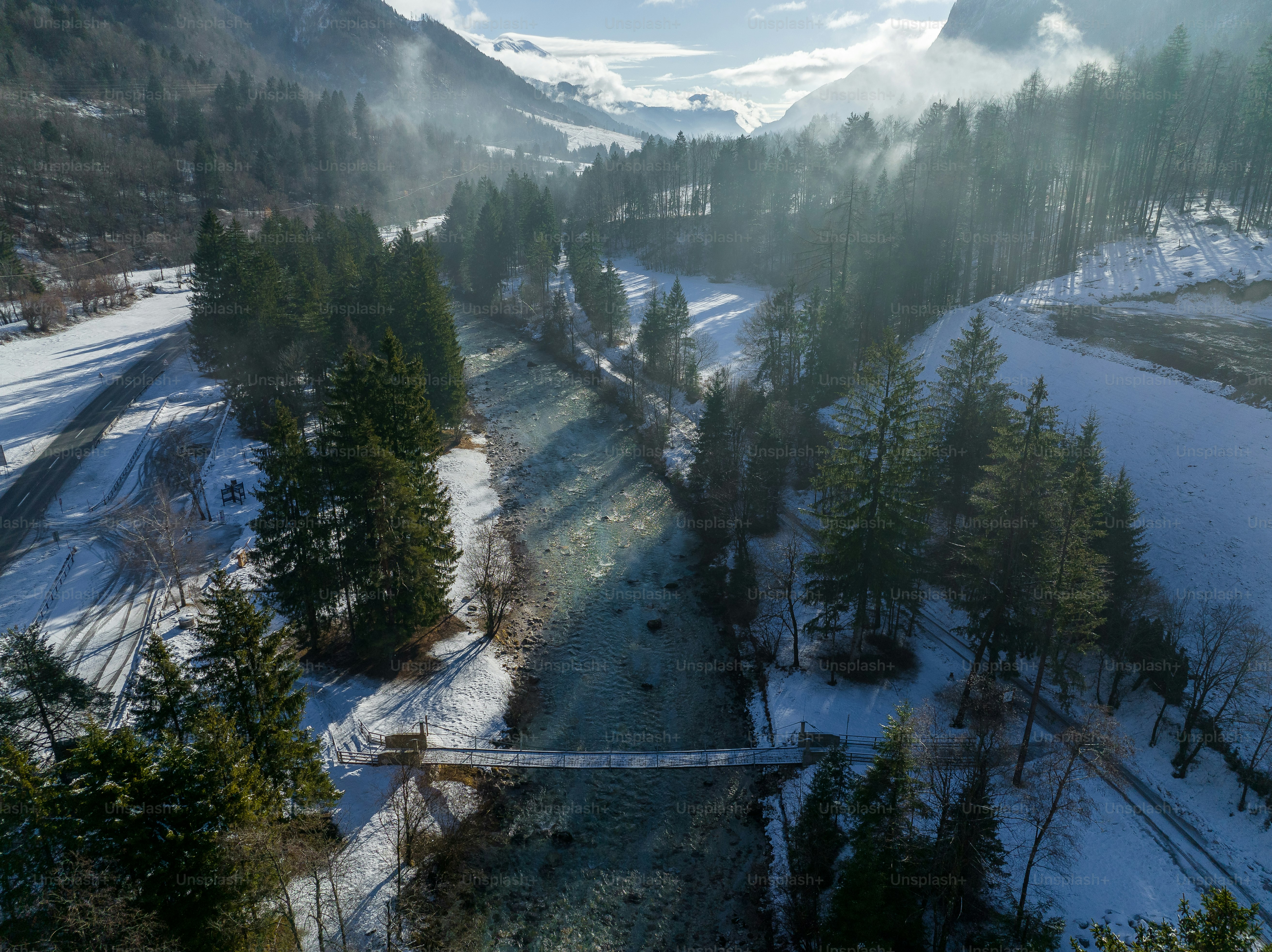 A river running through a snow covered forest photo – Valley Image on ...