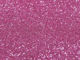 a close up of a pink glitter background