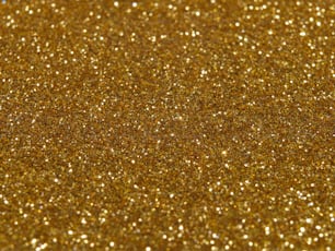 a close up of a gold glitter background