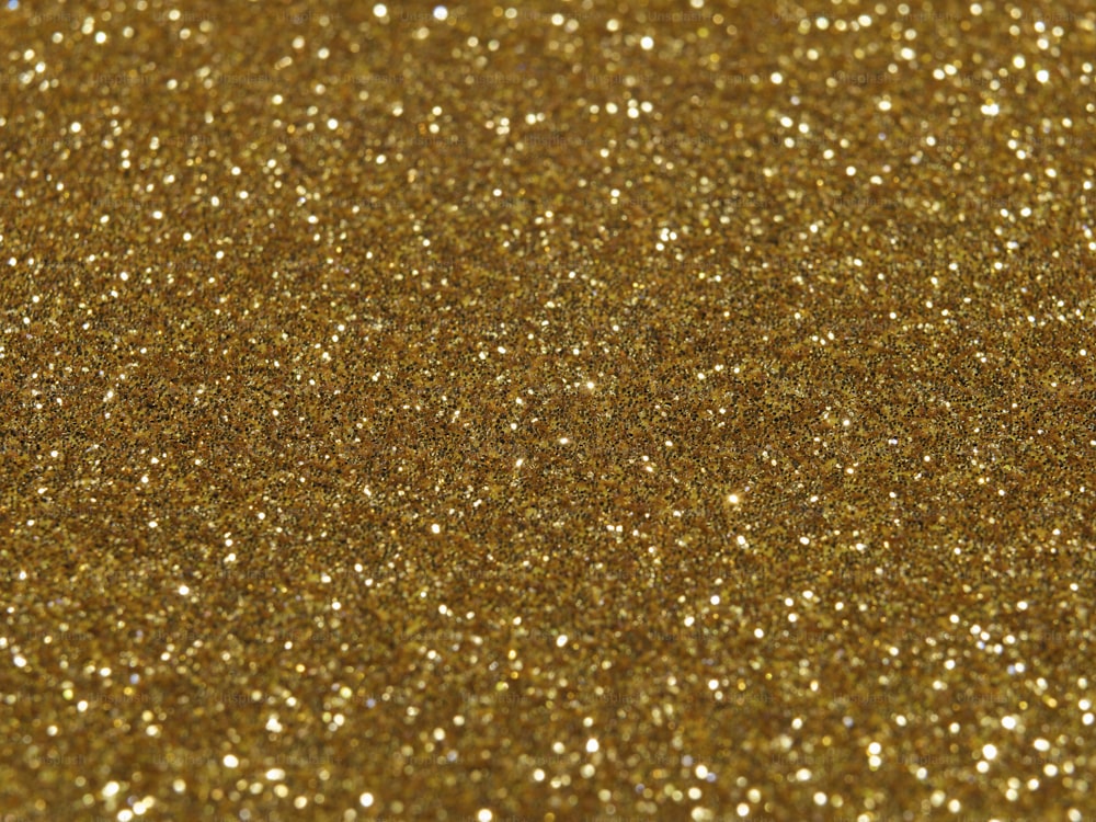 a close up of a gold glitter background