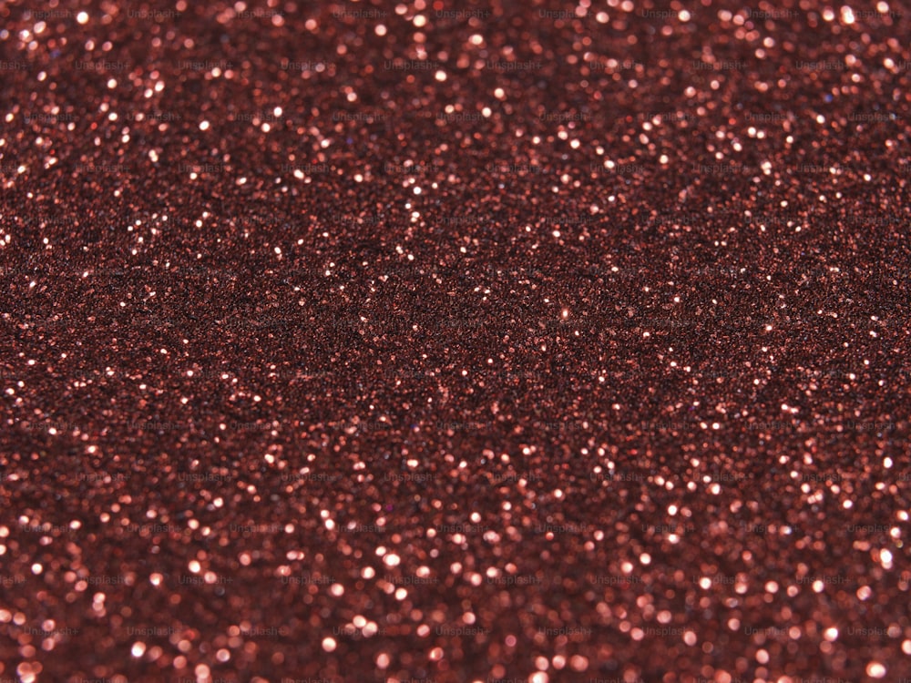 a close up of a red glitter background