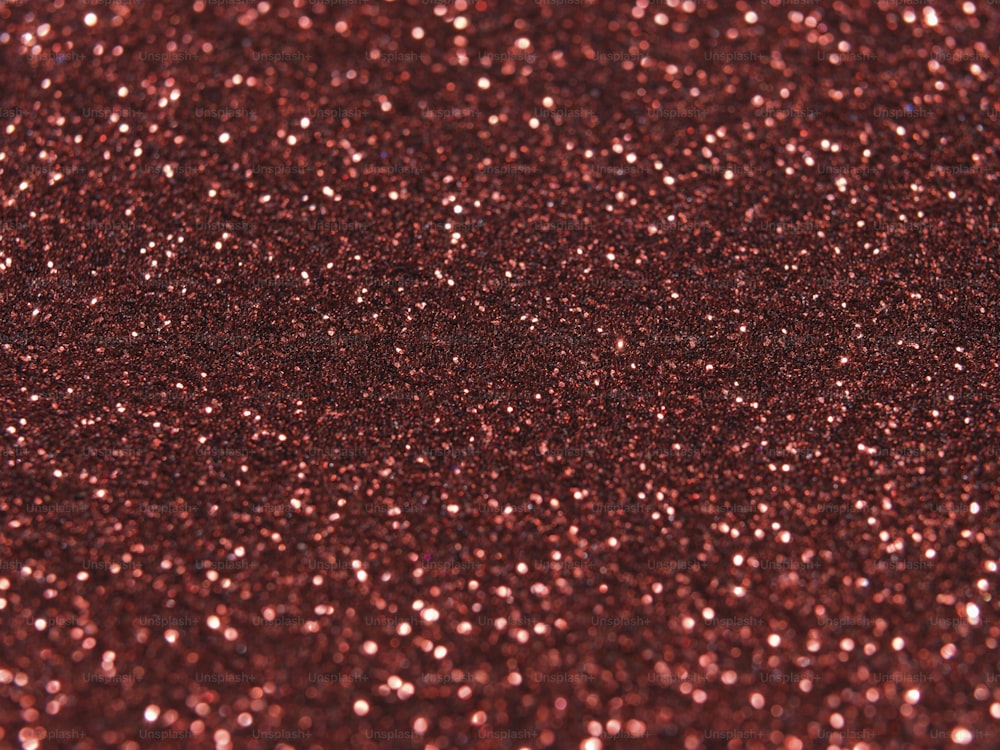 a close up of a red glitter background