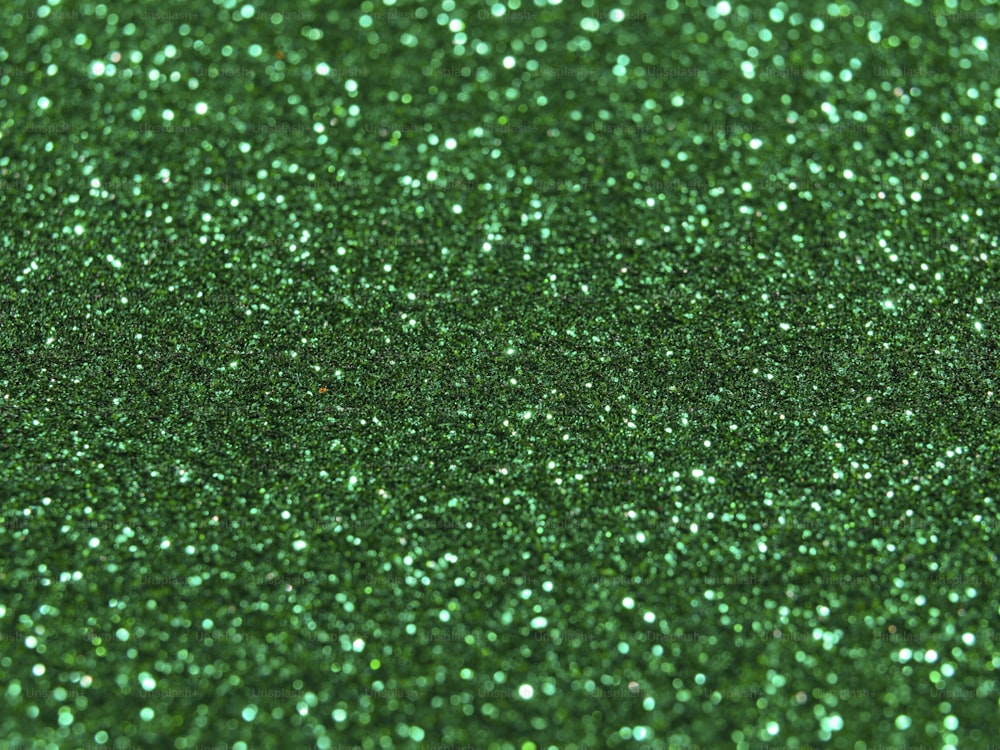 a close up of a green glitter background