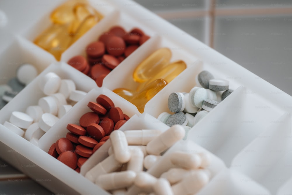 a pill tray filled with pills and capsules