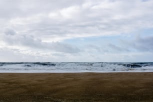 a large body of water sitting on top of a sandy beach