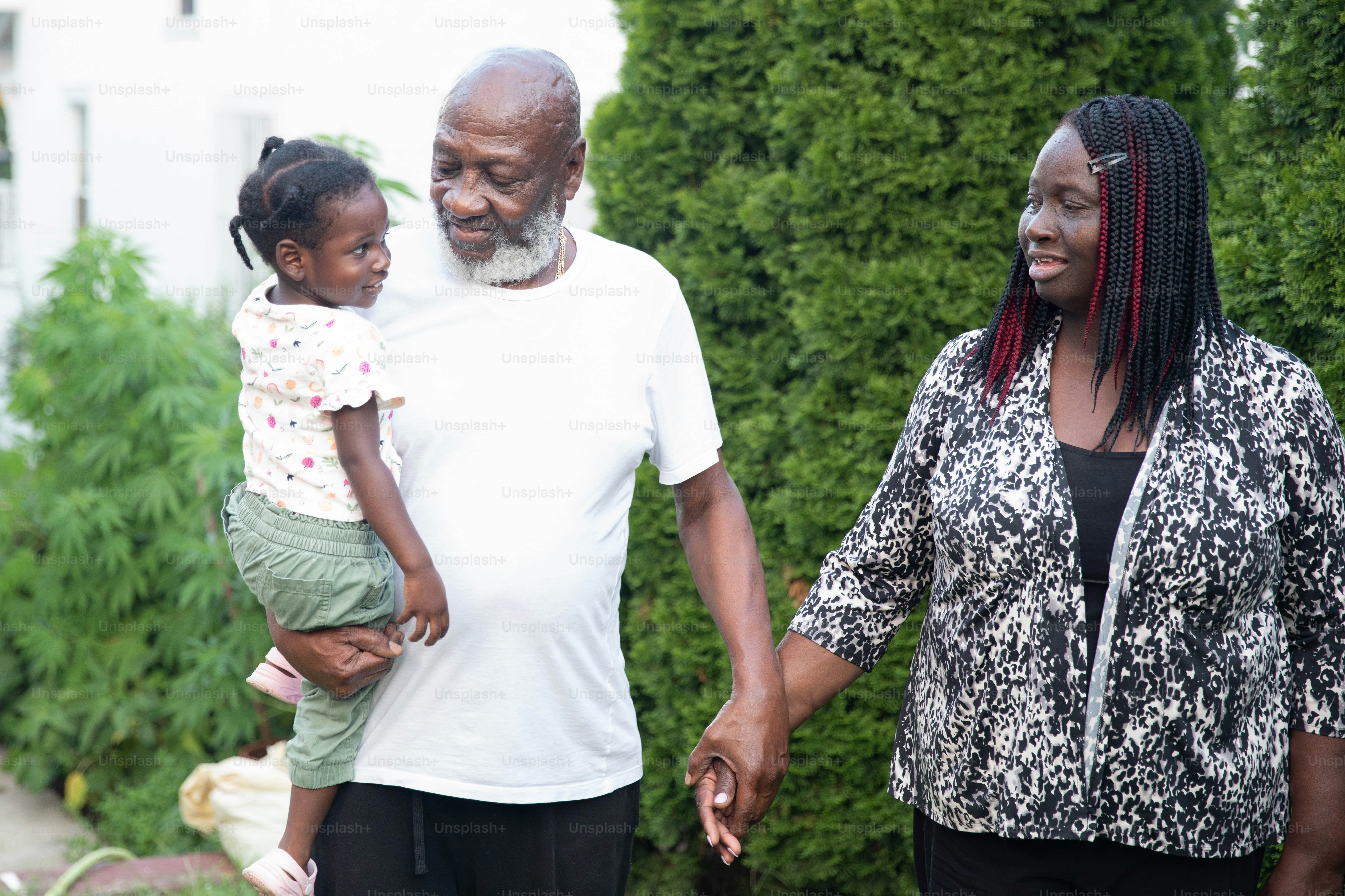 a man and a woman holding a small child