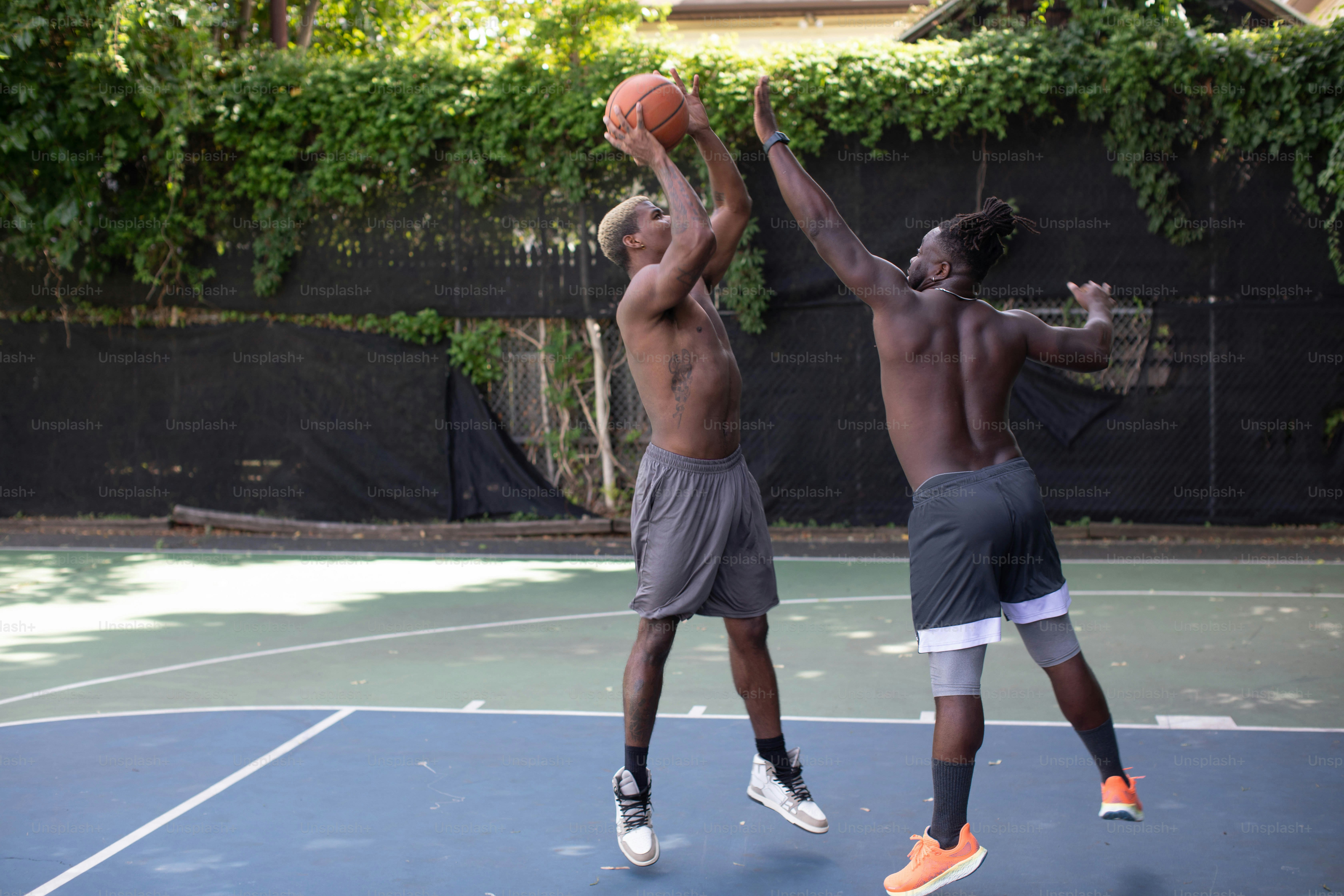 a couple of men playing a game of basketball