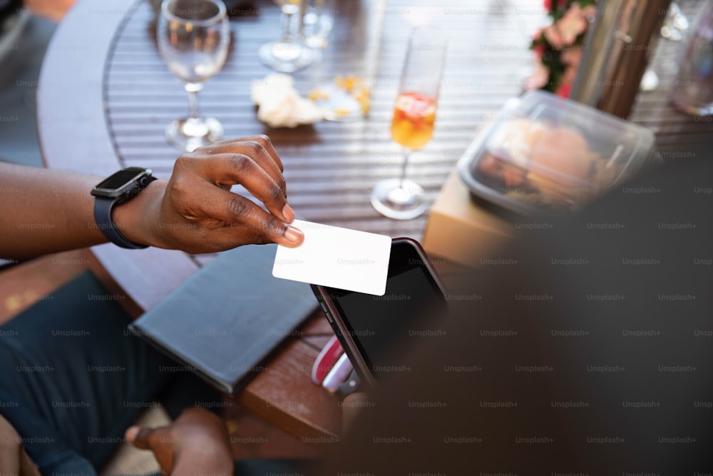 Una persona sentada en una mesa con una tarjeta en la mano