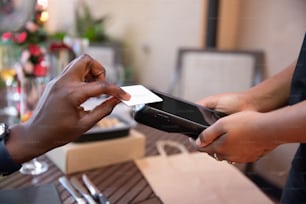 a person handing another person a credit card