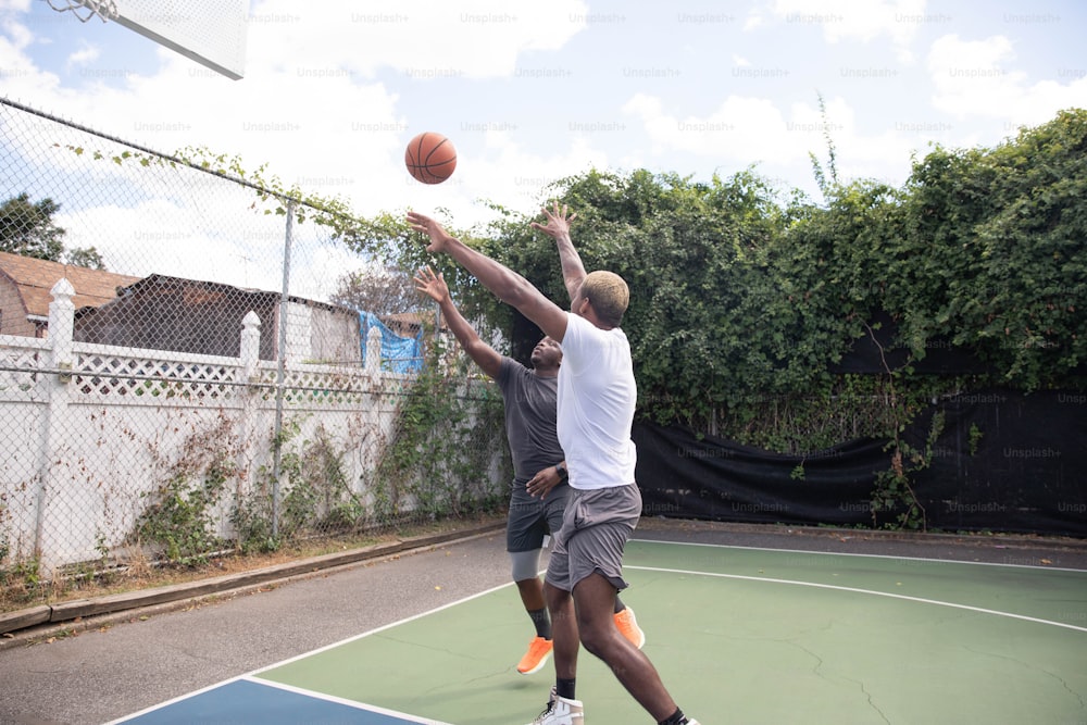 a couple of men playing a game of basketball
