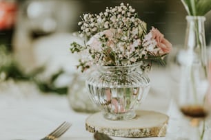 a vase filled with flowers sitting on top of a table