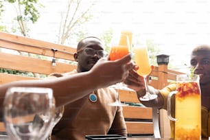 a couple of people sitting at a table with drinks