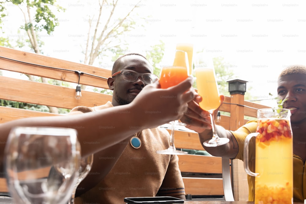 a couple of people sitting at a table with drinks