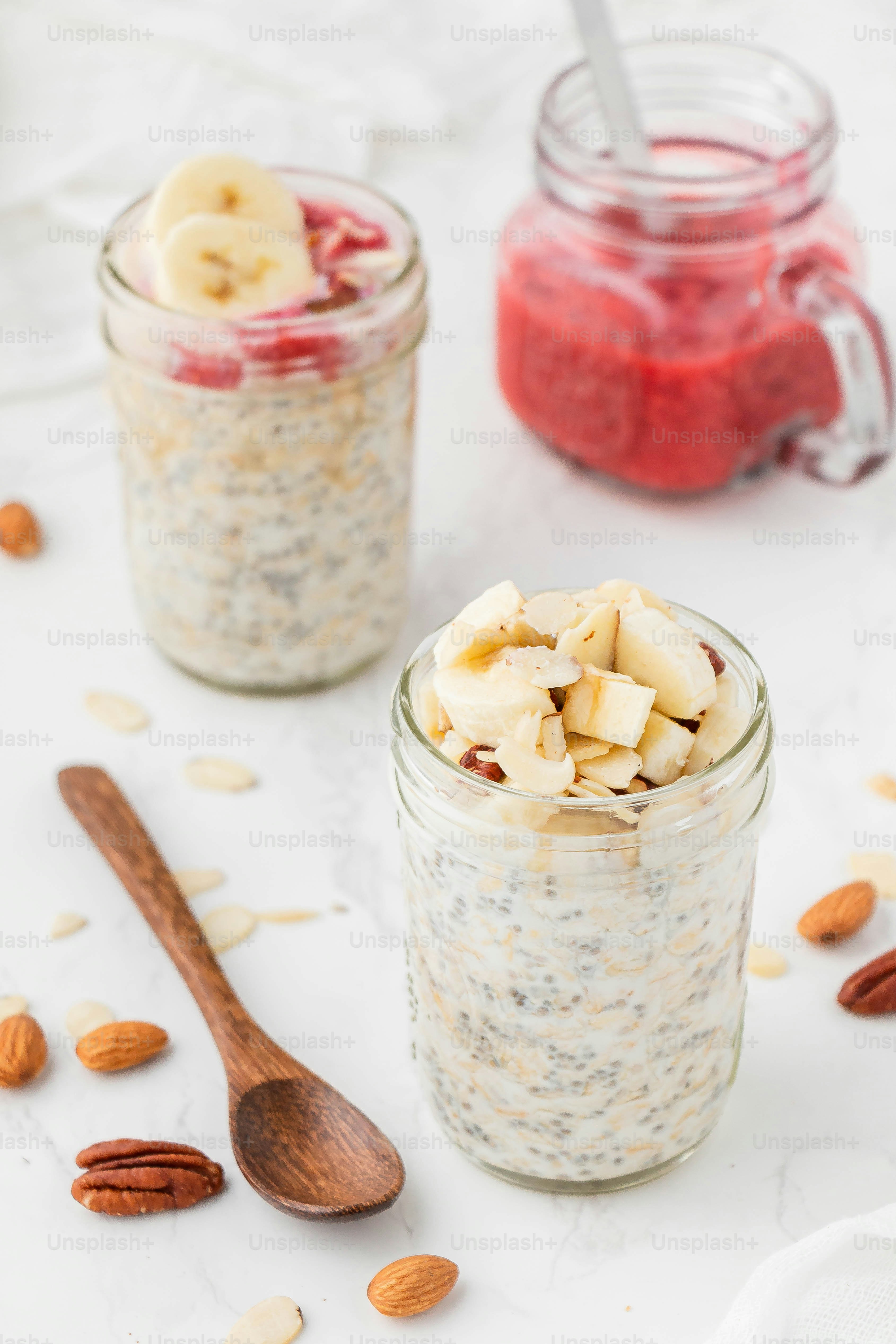 two jars filled with oatmeal and sliced bananas
