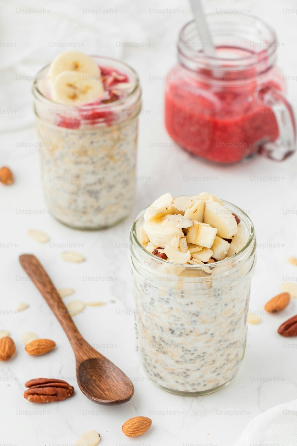 two jars filled with oatmeal and sliced bananas