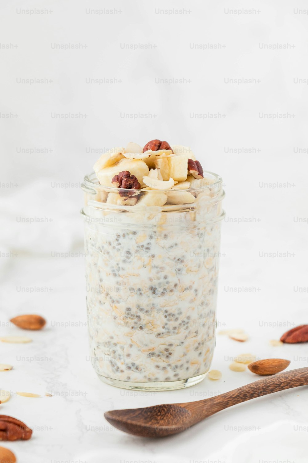 a glass jar filled with oatmeal and nuts