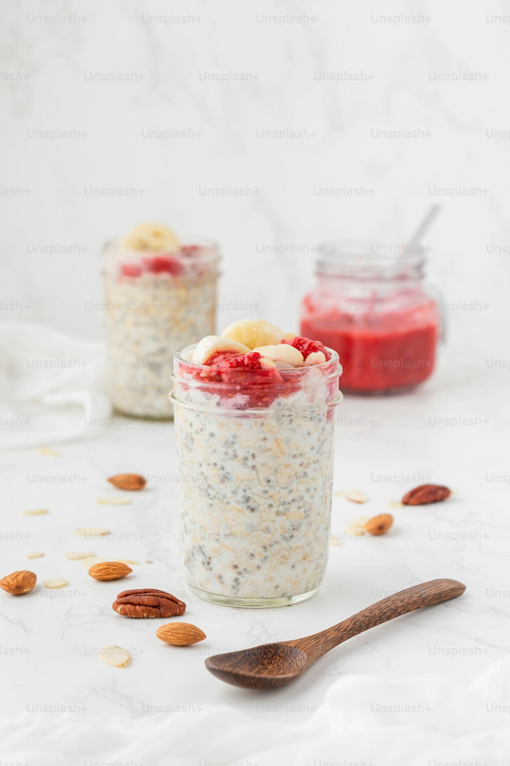 two jars of oatmeal with fruit and nuts