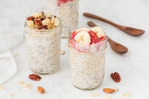 two jars filled with oatmeal and fruit