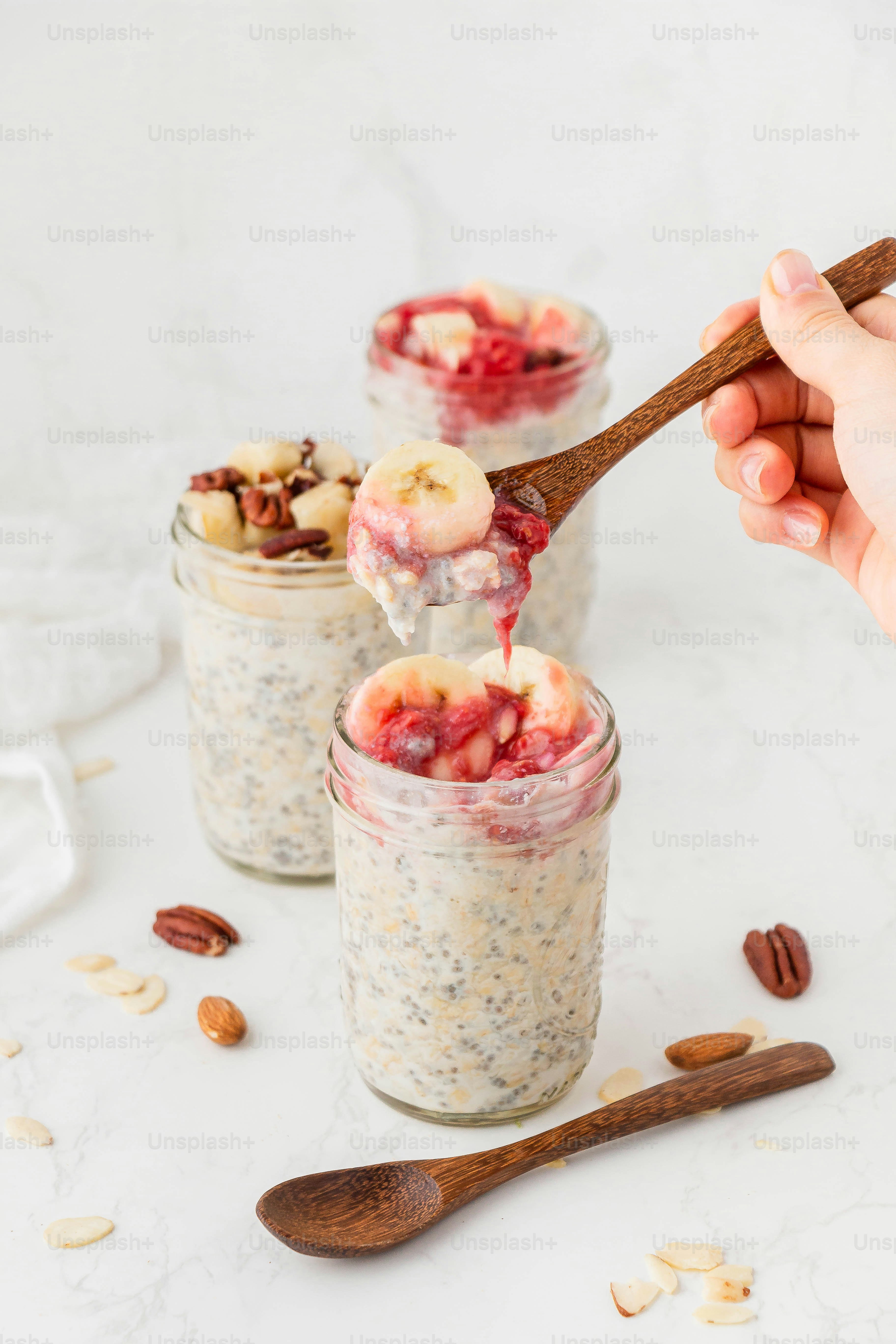 a hand holding a spoon full of oatmeal