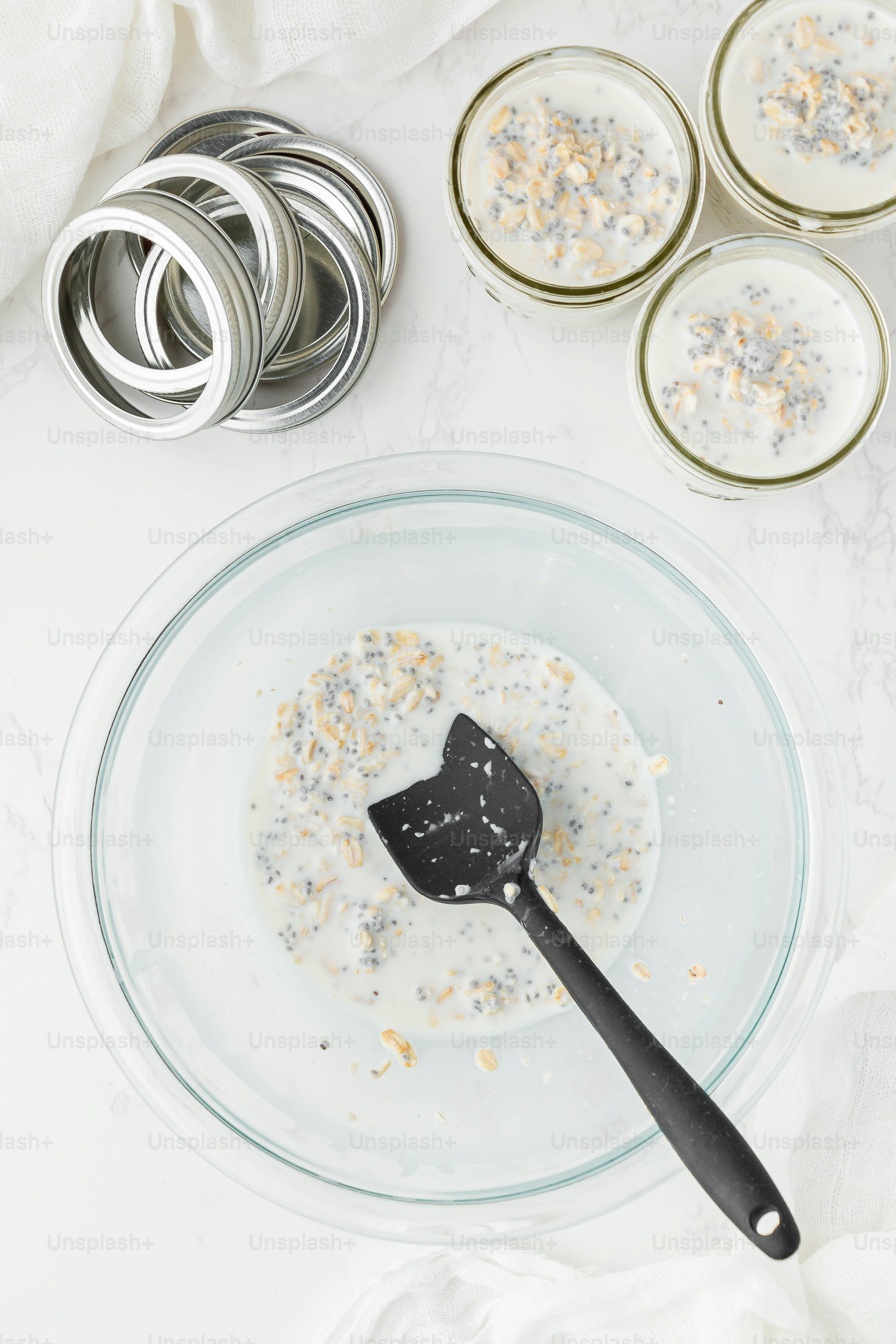 a glass bowl filled with oatmeal and a spoon