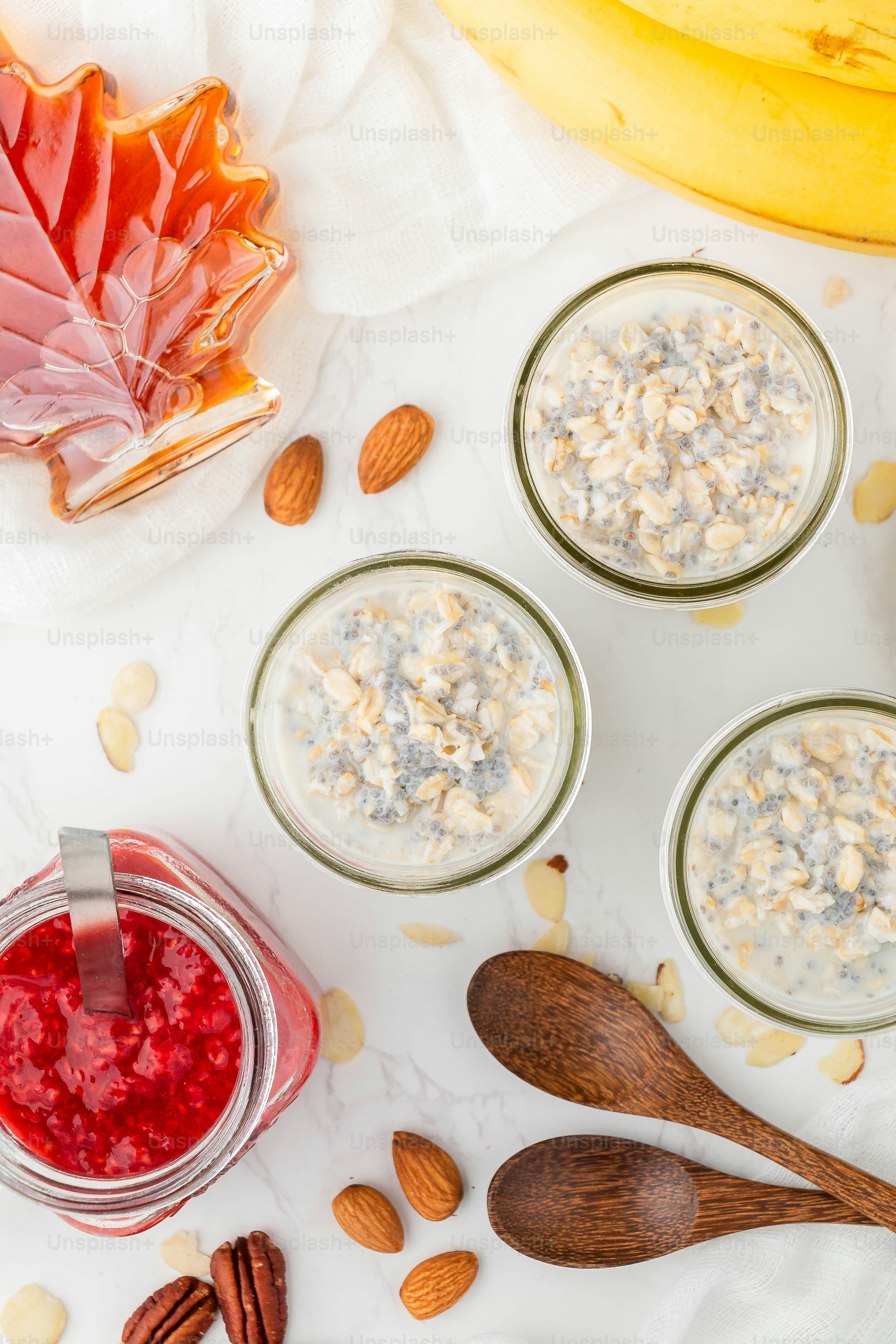 a table topped with three jars of oatmeal