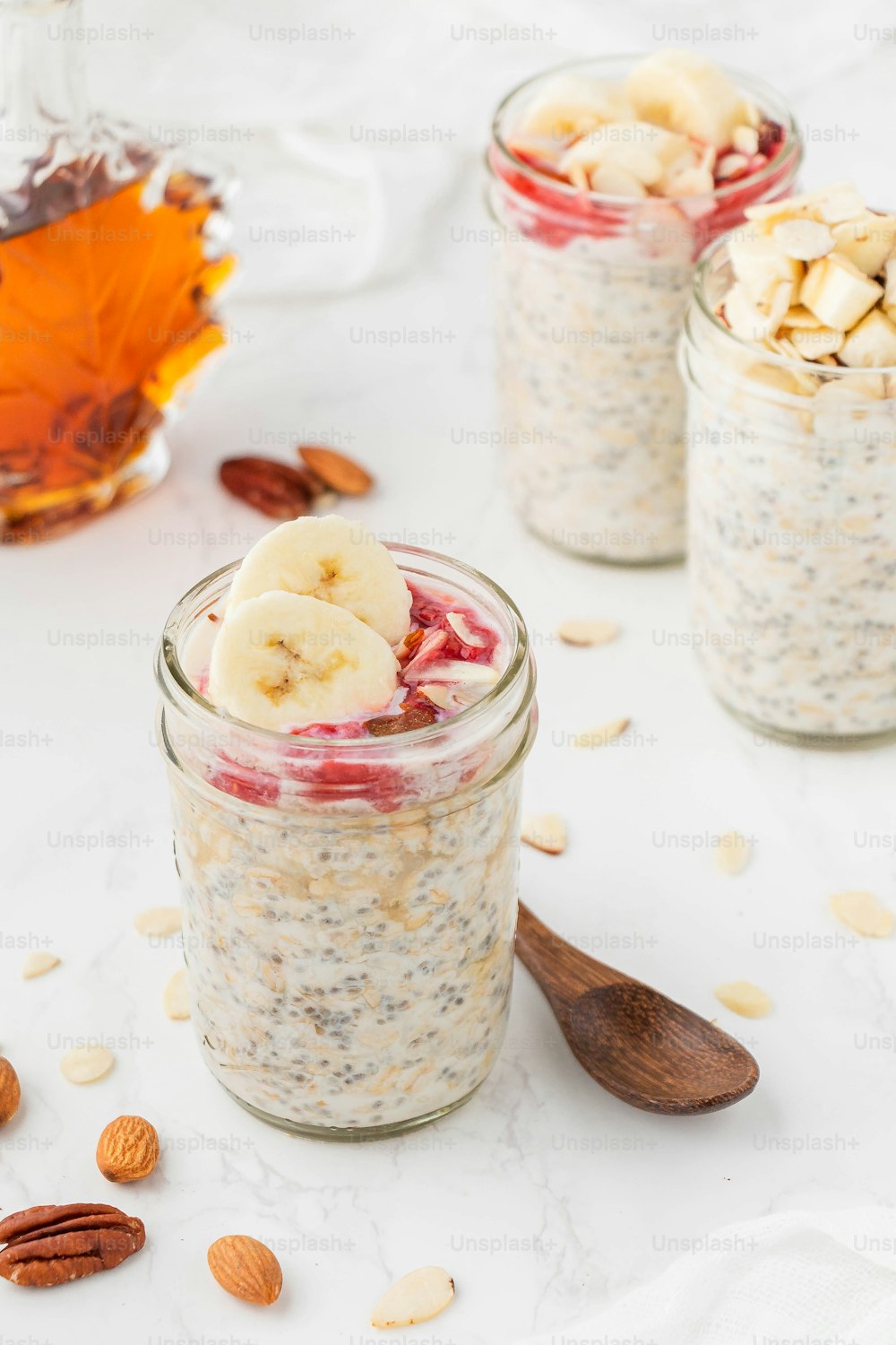 two jars of oatmeal with bananas and almonds