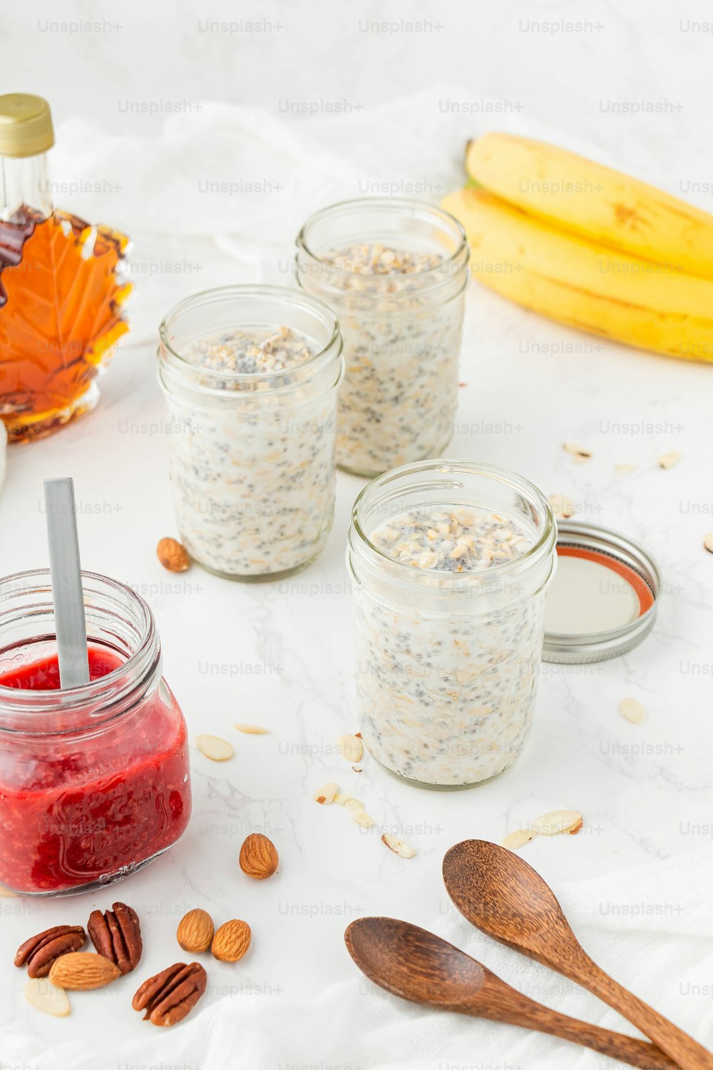 a table topped with jars filled with oatmeal
