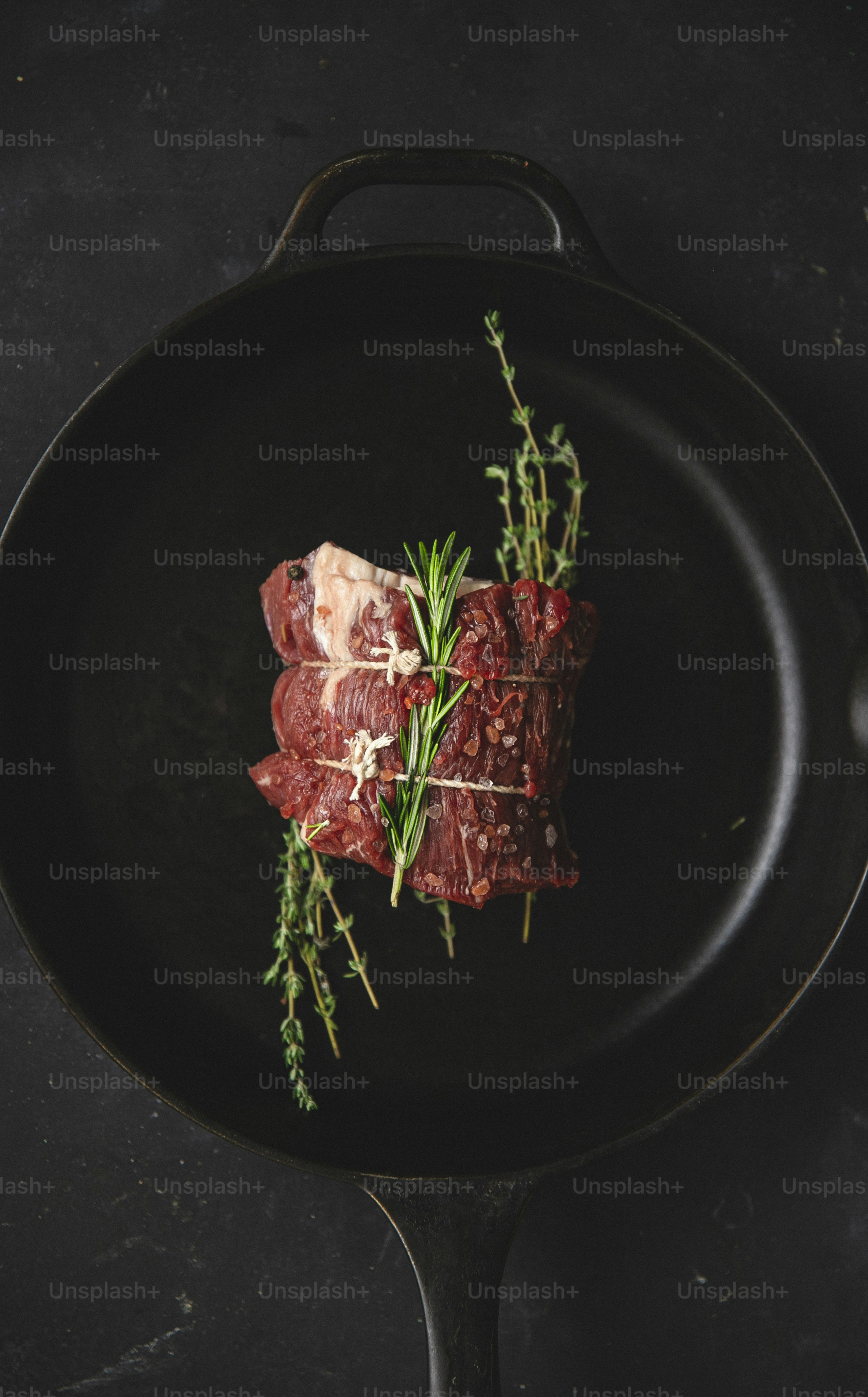 a piece of meat sitting on top of a frying pan