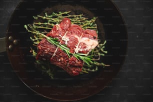 a plate of meat and asparagus on a table