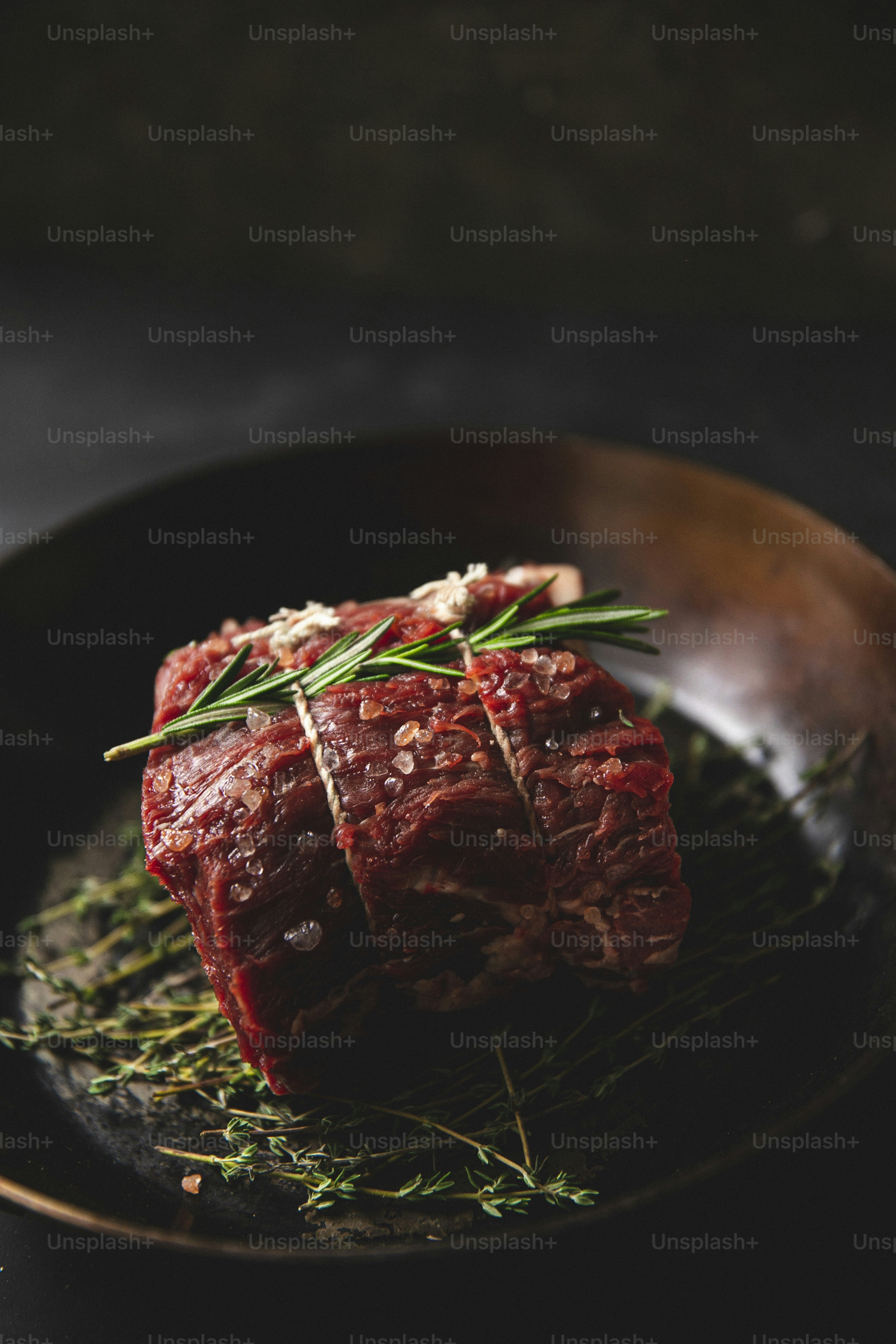a piece of meat sitting on top of a black plate