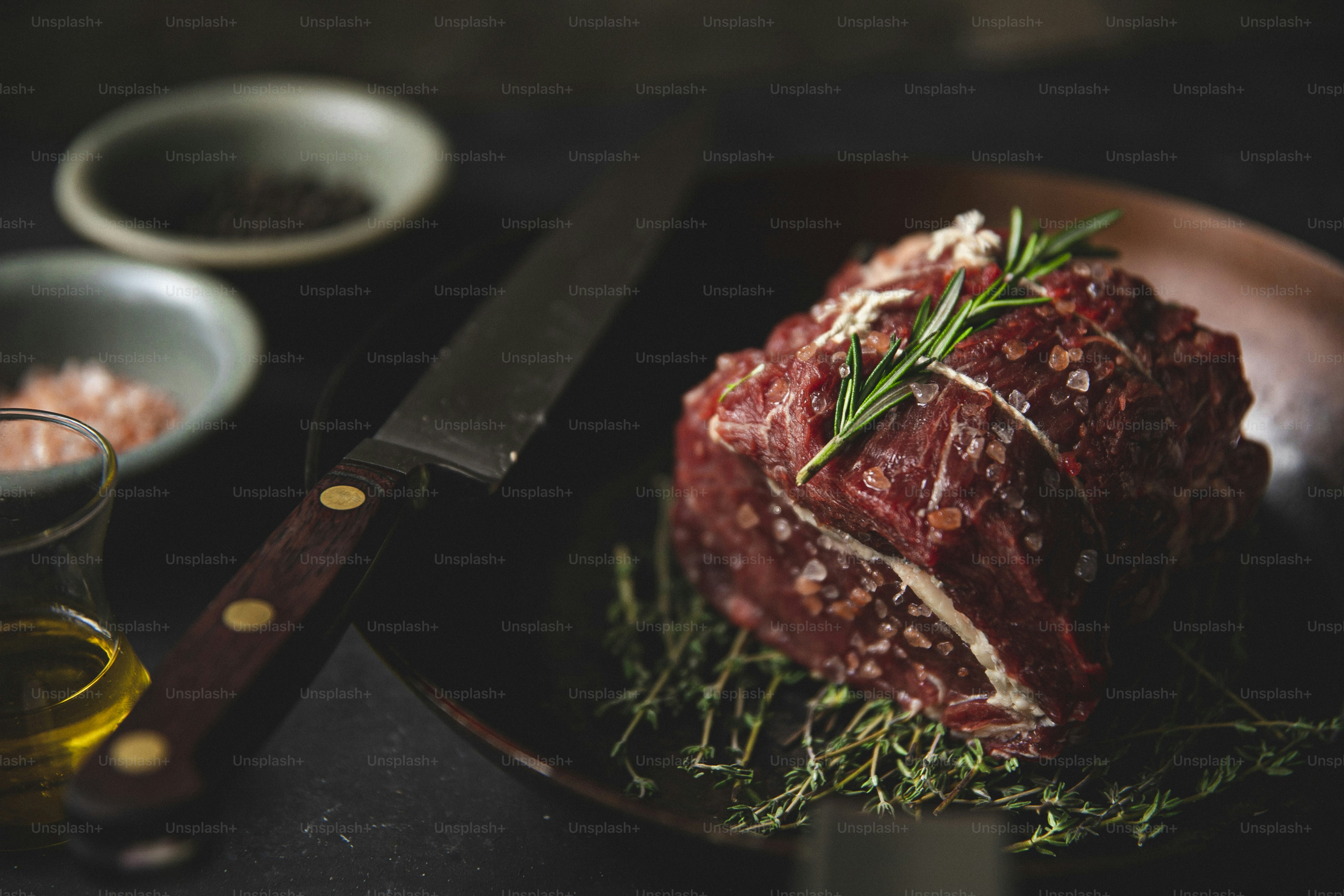 a piece of meat on a plate with a knife