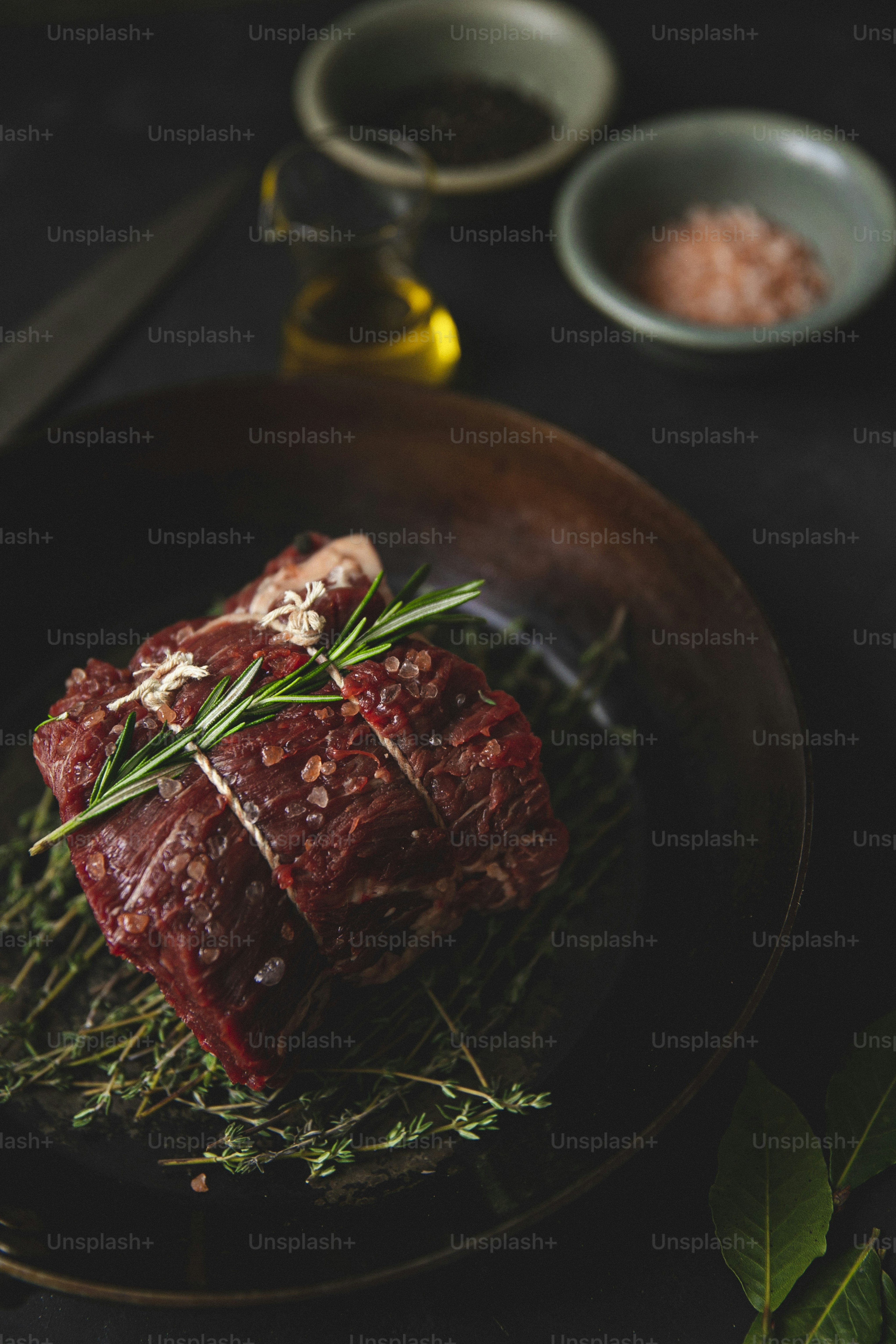 a piece of meat sitting on top of a black plate