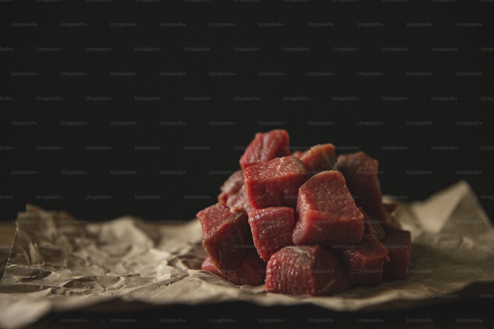 a pile of raw meat sitting on top of a piece of wax paper
