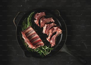 a skillet with some meat in it on a table